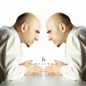 Bald man in a white shirt looking at his own reflection