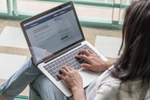 hands on a laptop using Facebook to create custom audiences