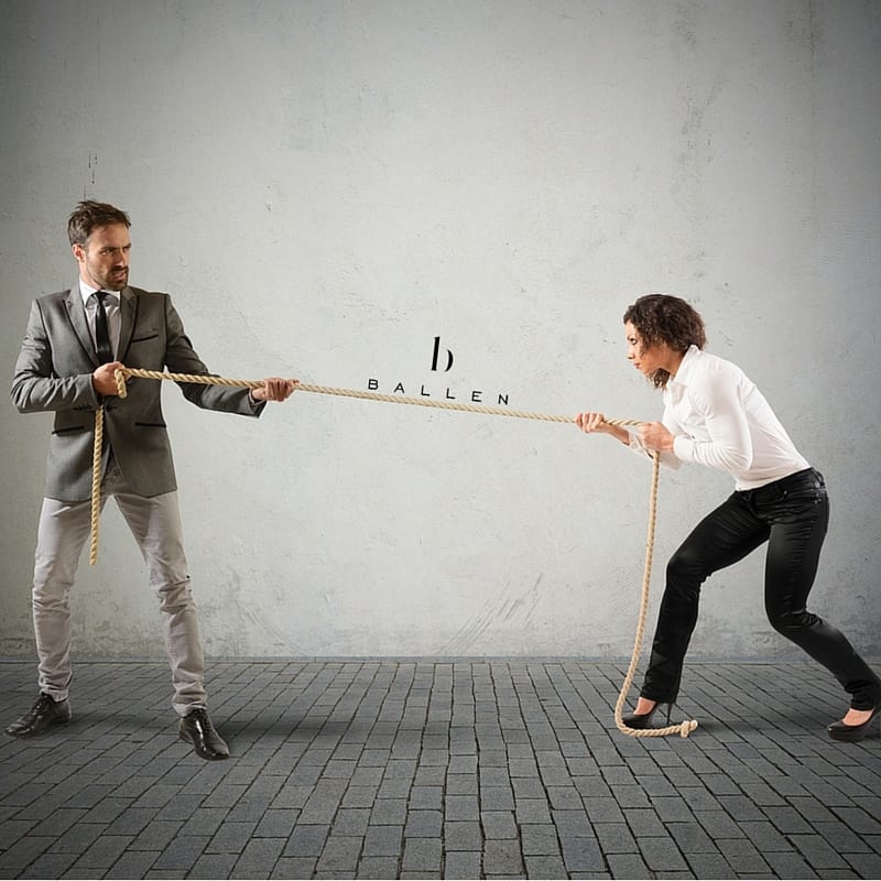 business professionals playing tug of war