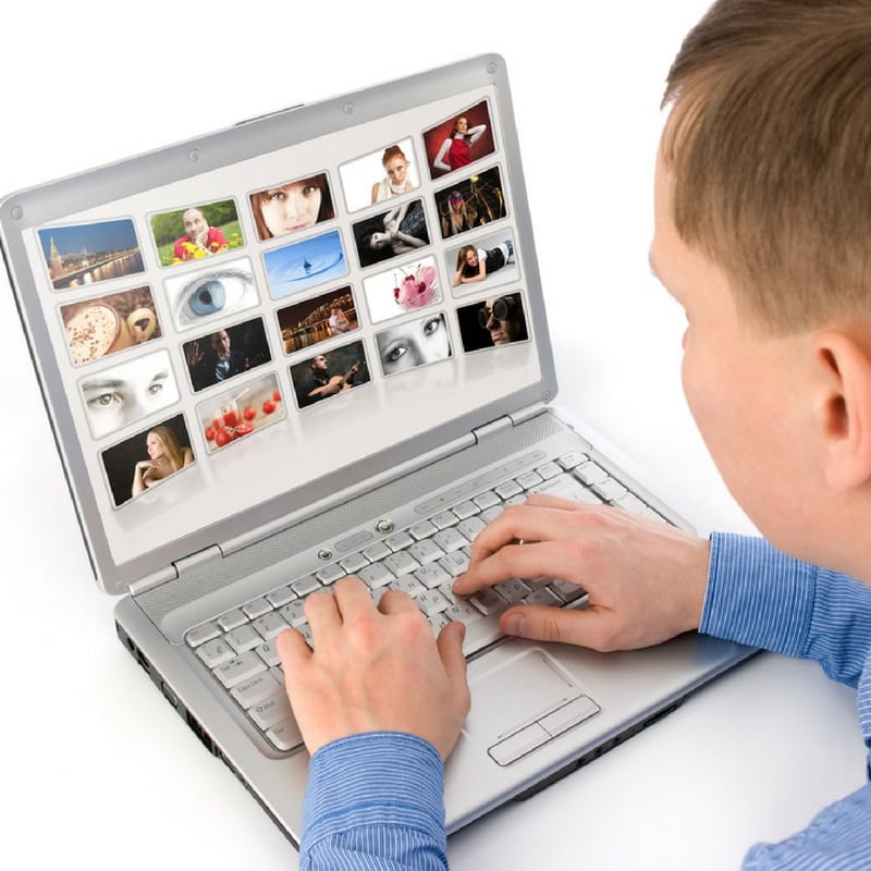 man using a laptop for image optimization