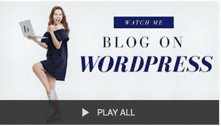 Girl is wearing a blue dress. She's happy with her thumb up and holding a computer. Thumb points a bit back to words Watch Me Blog on Wordpress. A play all button is at the bottom.