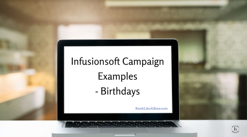 Computer is sitting on a table and is open. It reads "Infusionosft Campaign Examples - Birthday"