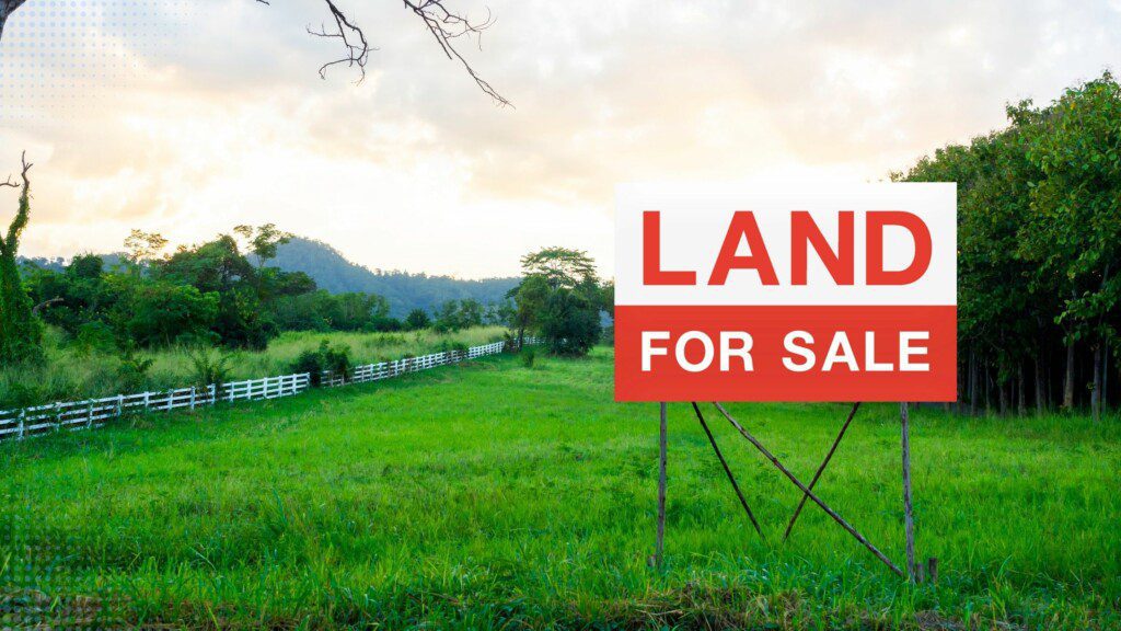 Land for sale sign is on a large piece of land, green